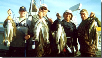 Happy Guest with Limits of Speckled Trout.